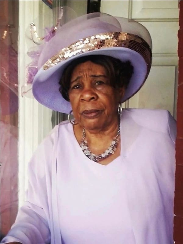 Portrait of woman in elegant lavender outfit with hat